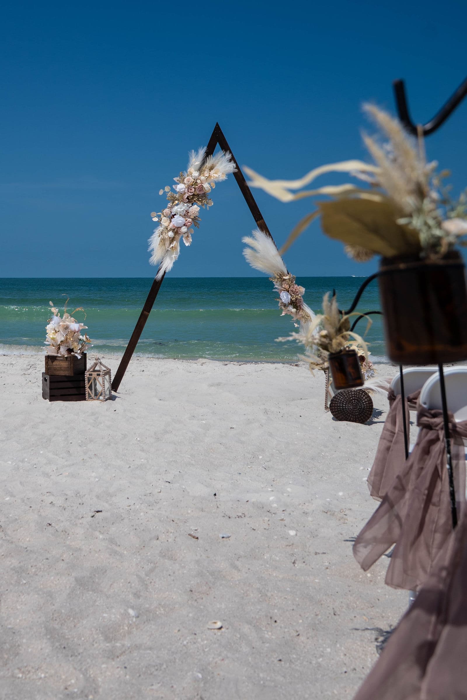 Couple celebrating at a Florida beach wedding ceremony, real client photo by Florida Weddings