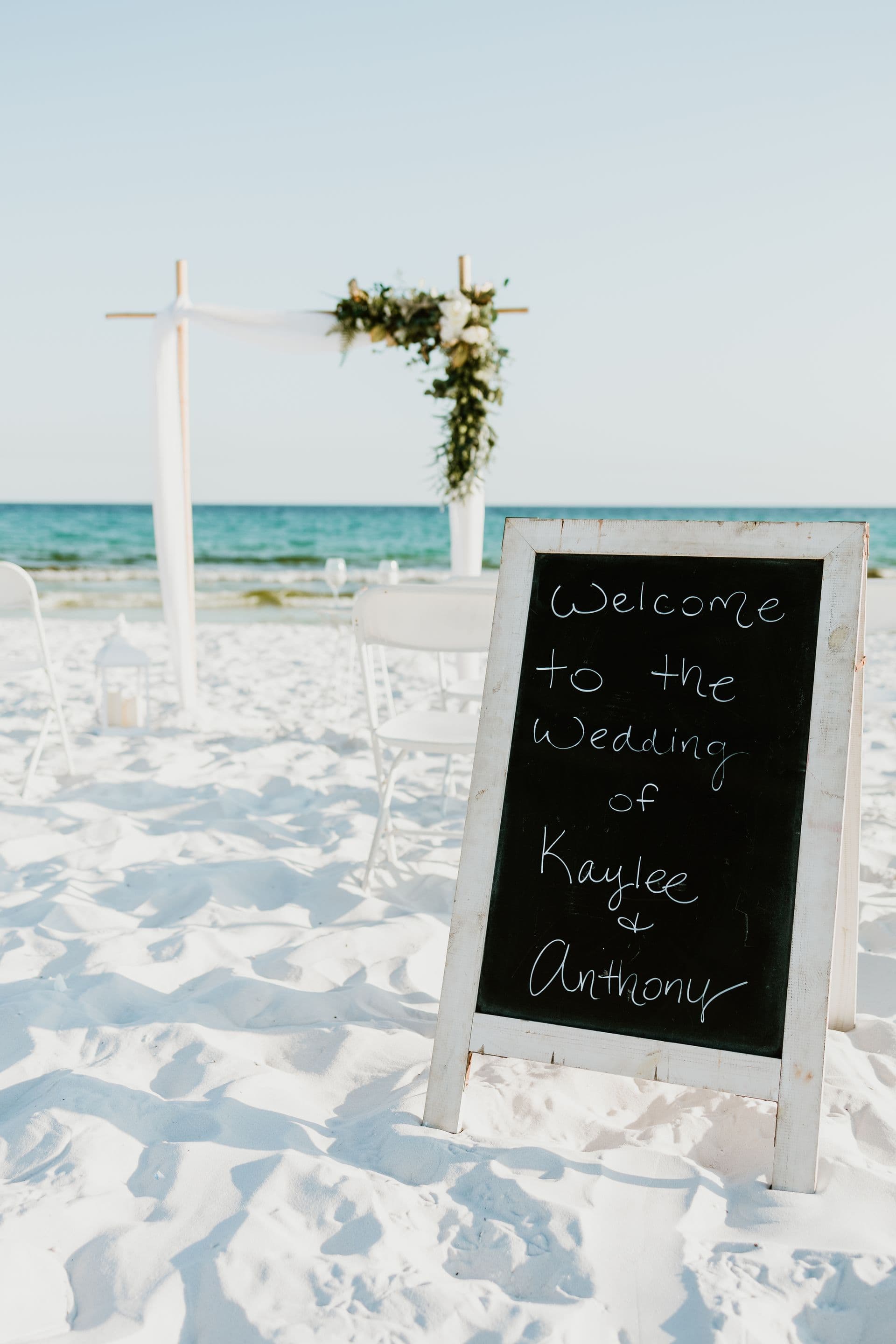 Sunset ceremony framed by a bamboo wedding arch