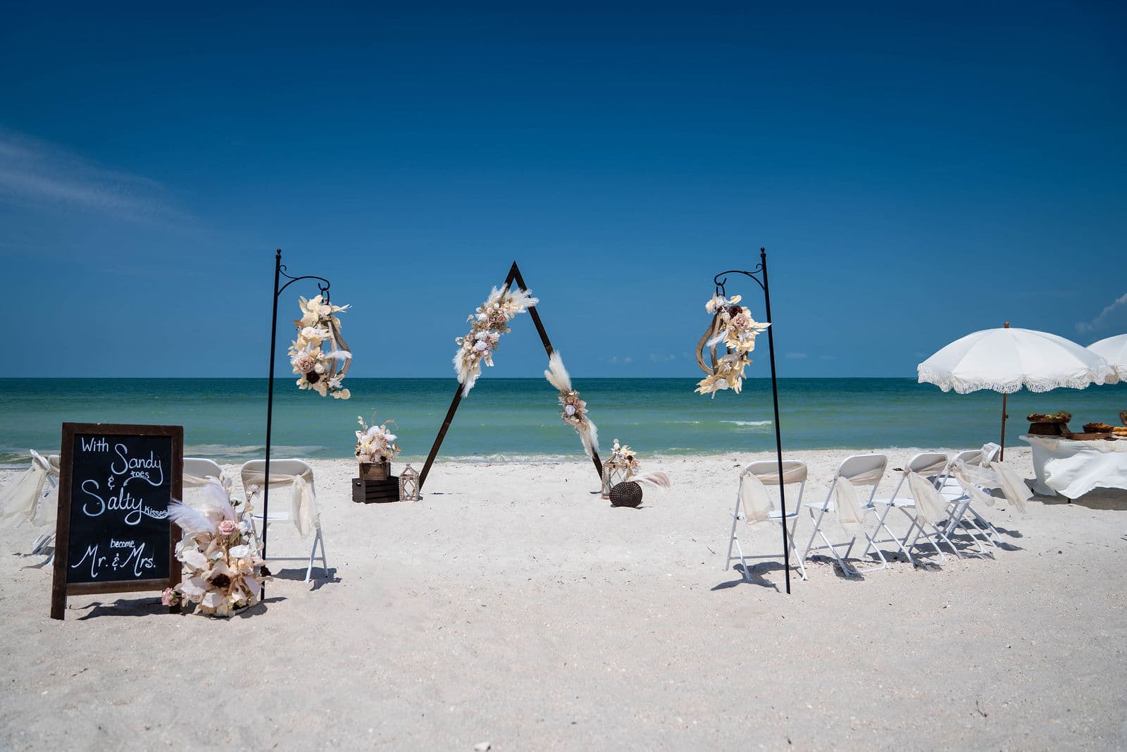 A-frame wedding arch and ceremony seating on a Florida beach