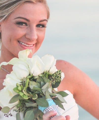 A bride holding a beautiful bouquet of white flowers